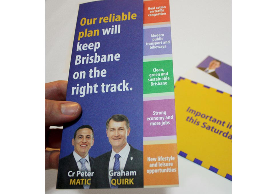 Graphic design, hand holding Lord Mayor Graham Quirk trifold brochure and envelope by Maya Walker